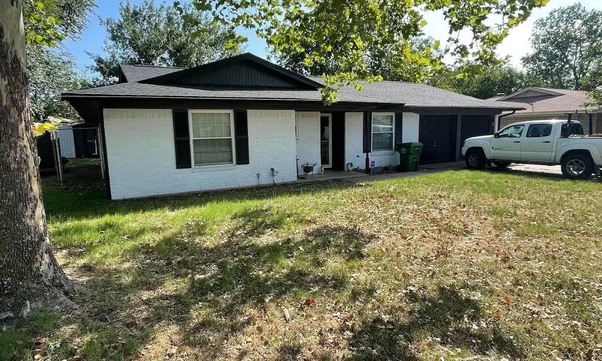 Professional roofing crew working on a residential roof in McPherson
